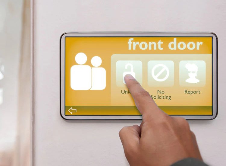 Hand pressing a front door alarm touchscreen